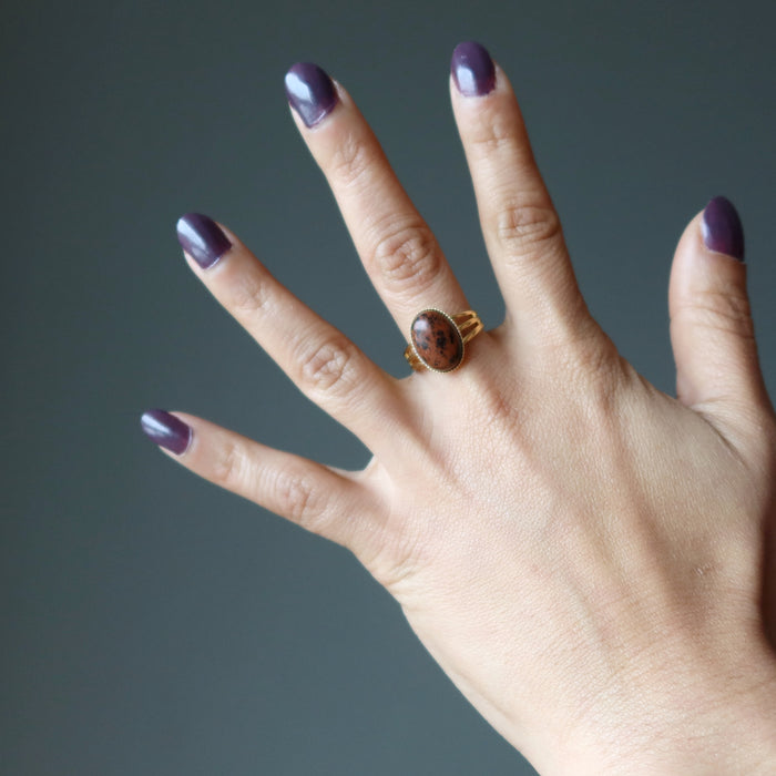 hand wearing mahogany obsidian gold ring