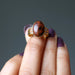 hand holding mahogany obsidian gold ring