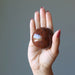 mahogany obsidian sphere in hand