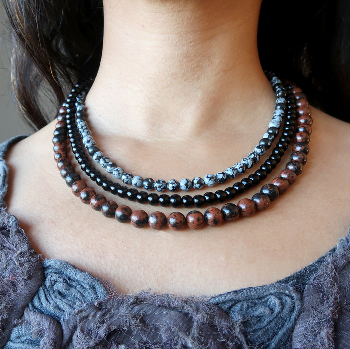 woman wearing triple strand obsidian necklace