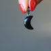 holding female model wearing Crescent Moon Black Obsidian Pendant 