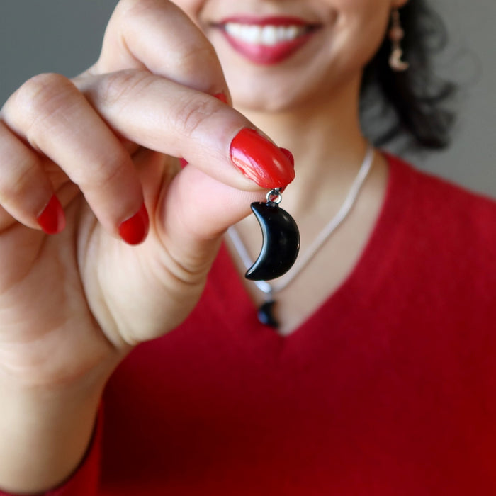 holding female model wearing Crescent Moon Black Obsidian Pendant 