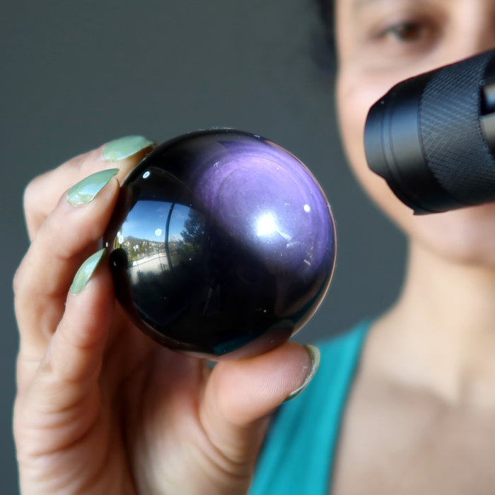 purple obsidian sphere in flashlight