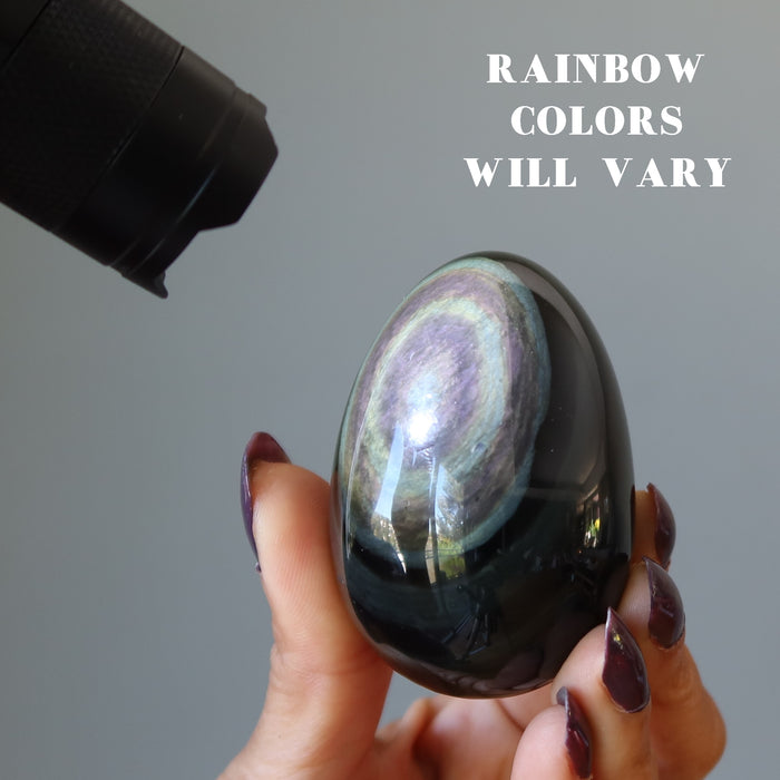 rainbow obsidian egg under flashlight