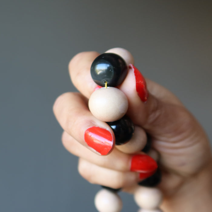 showing the rainbow on obsidian necklace