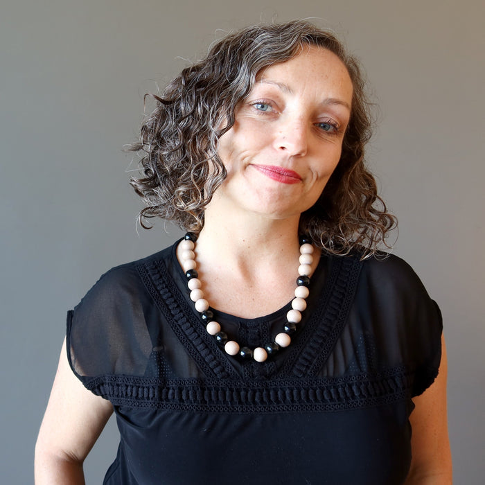 woman wearing rainbow obsidian and wood necklace