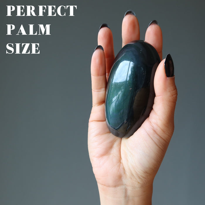 hand holding rainbow obsidian palm stone