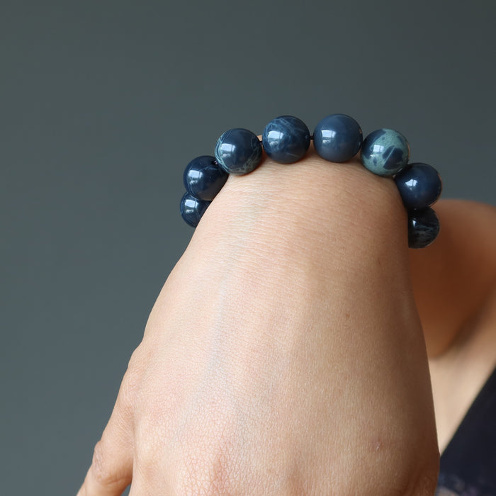  round spiderweb obsidian stretch bracelet on wrist