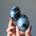 hand holding 2 Spiderweb Obsidian Egg