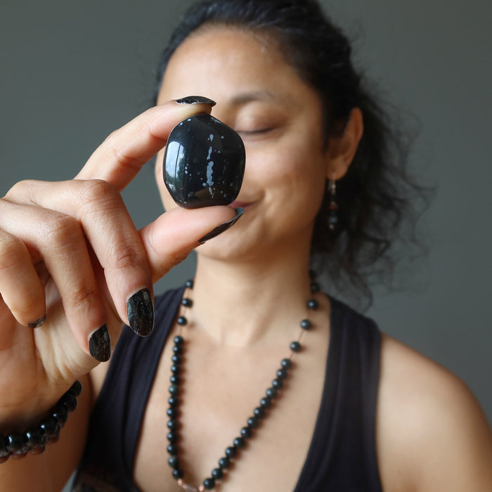 sheila of satin crystals holding snowflake obsidian stone