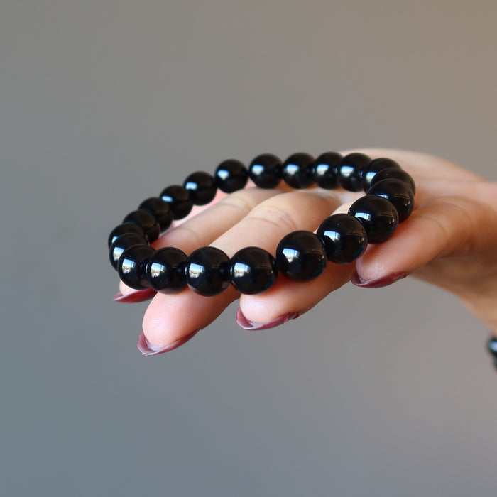 hand holding out black onyx bracelet