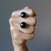 fist holding black onyx cufflinks