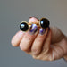 hands holding black onyx cufflinks