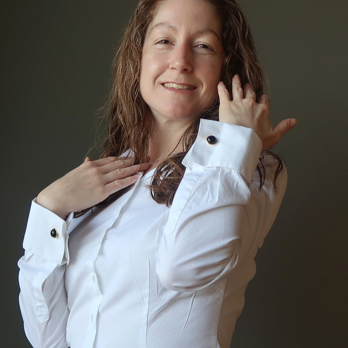 female wearing gold black onyx cufflinks