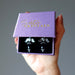 hand holding satin crystals gift box with onyx earrings