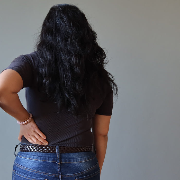 pink opal bracelet on the wrist of a lady with hand on her hip