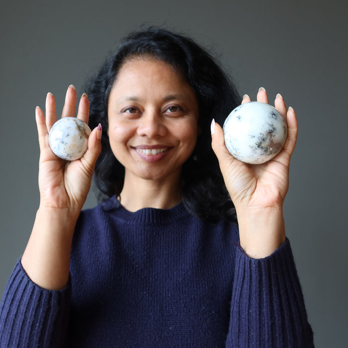 sheila of satin crystals holding two opal spheres