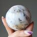 hand holding white opal sphere