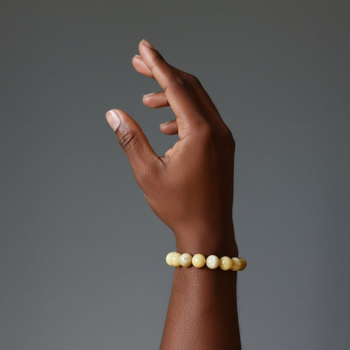 woman's hand wearing yellow opal beaded bracelet