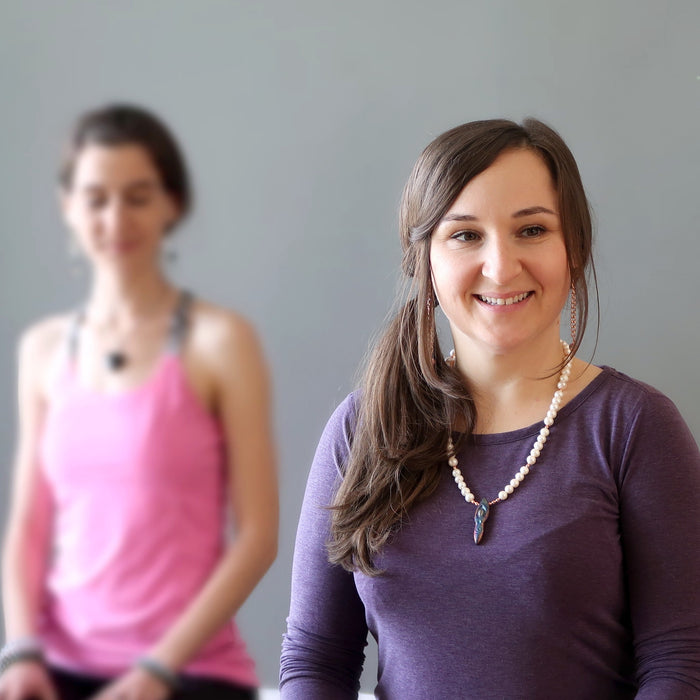 woman modeling pearl goddess necklace