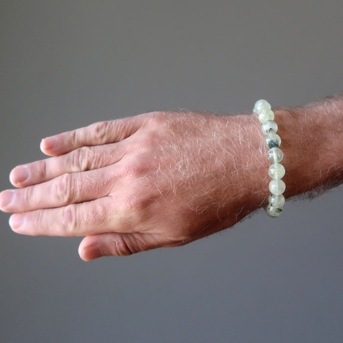 round beaded green prehnite bracelet on a male hand model