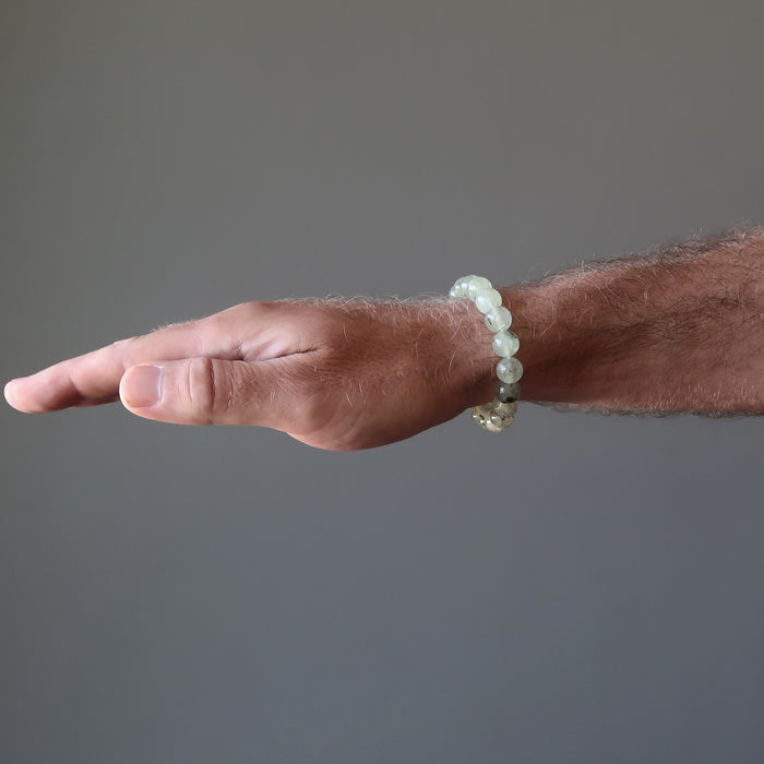 round beaded green prehnite bracelet on a male hand model