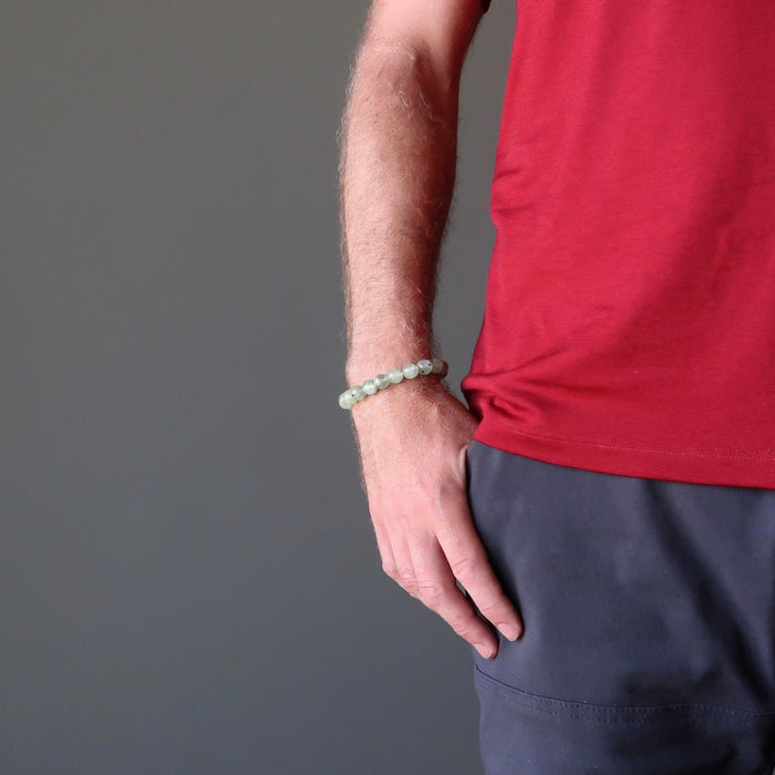 round beaded green prehnite bracelet on a male hand model