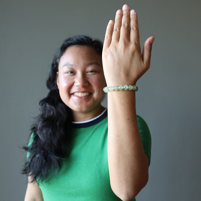 spring green prehnite gemstone bracelet on a smiling lady's wrist