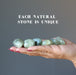 prehnite tumbled stones in hand