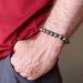 mans hand in pocket wearing round pyrite beaded stretch bracelet