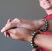 mens hands clasping wearing round pyrite beaded stretch bracelets
