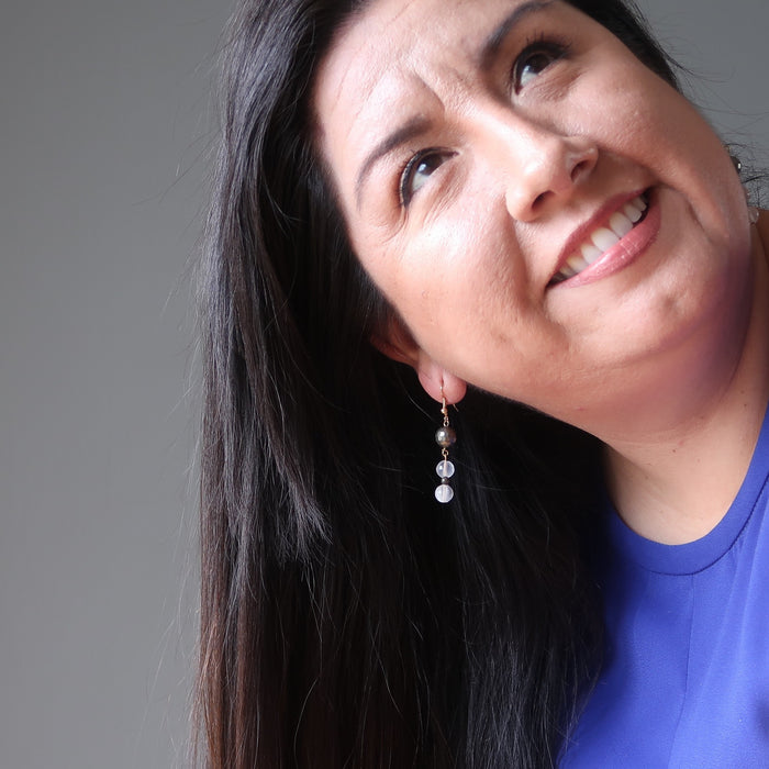valerie of satin crystals wearing faceted pyrite and white selenite dangle earrings