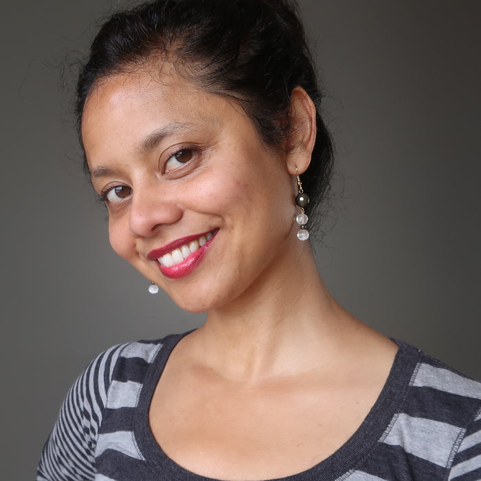 sheila  of satin crystals wearing faceted pyrite and white selenite dangle earrings