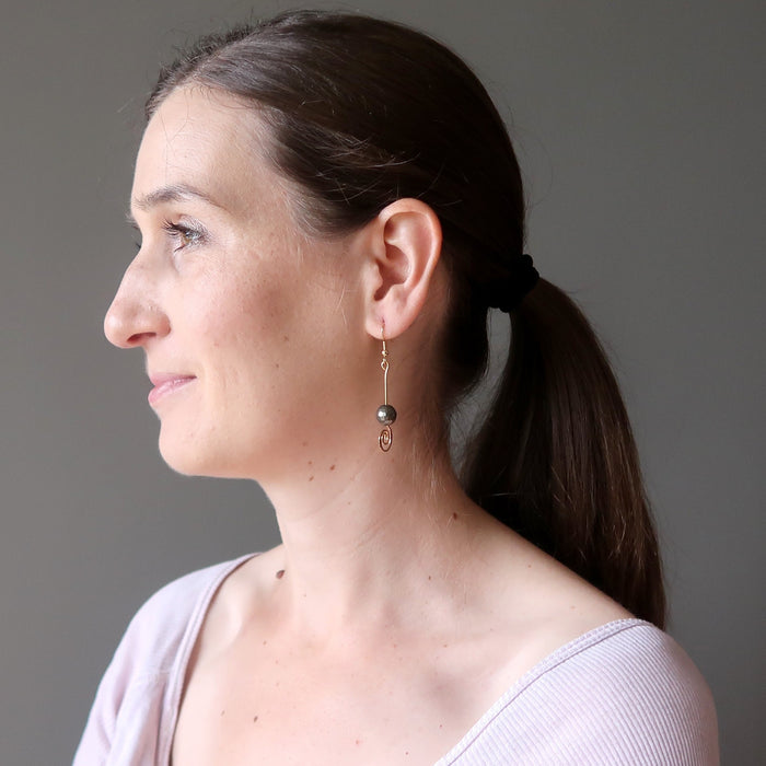 lucia of satin crystals wearing faceted pyrite beads on gold spiral earrings