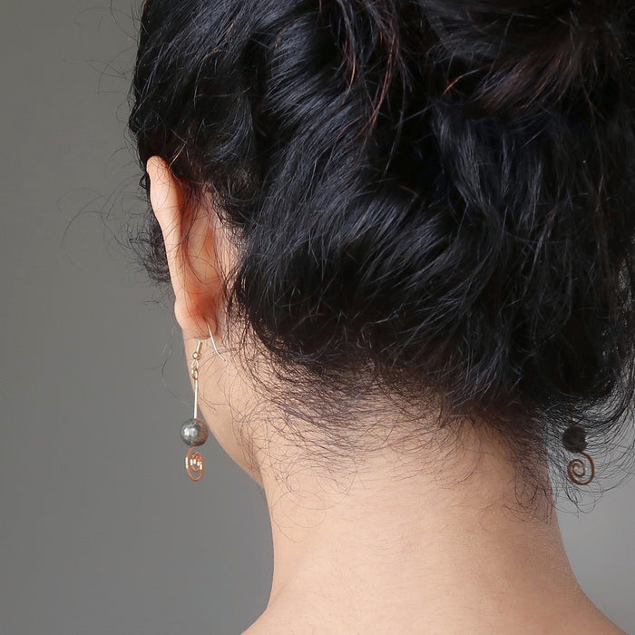 sheila of satin crystals wearing faceted pyrite beads on gold spiral earrings
