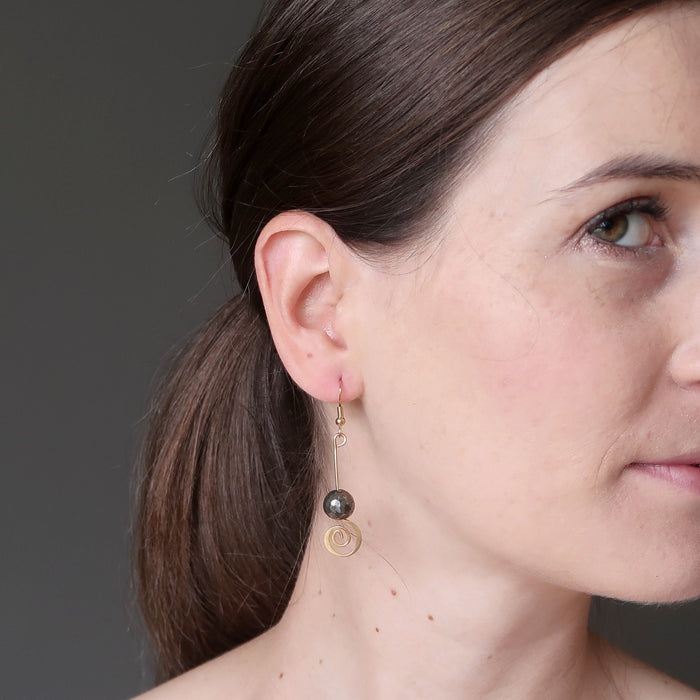 lucia of satin crystals wearing faceted pyrite beads on gold spiral earrings
