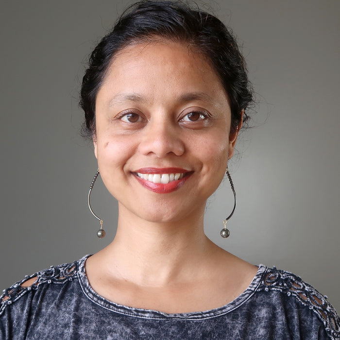 sheila of satin crystals wearing faceted pyrite on long curved earrings 
