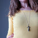 female wearing pyrite tigers eye angel necklace