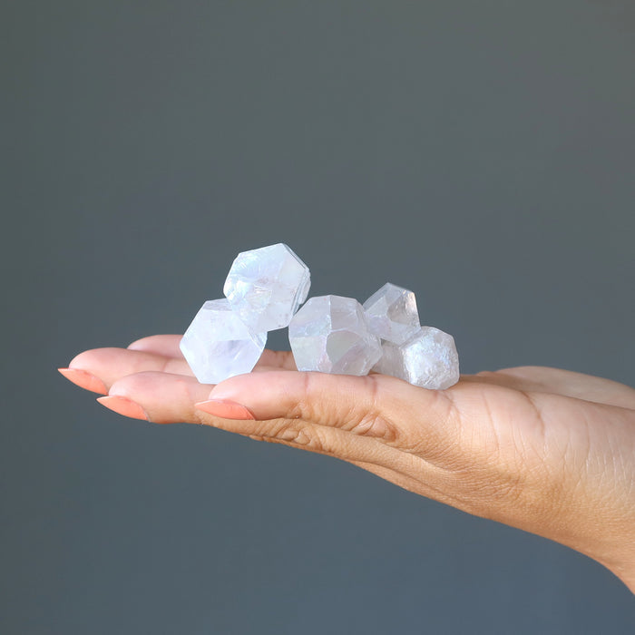 five aura Quartz Point Wands on the palm