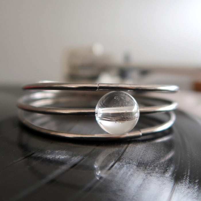 gunmetal memory wire triple coiled into a bracelet with clear quartz ball bead