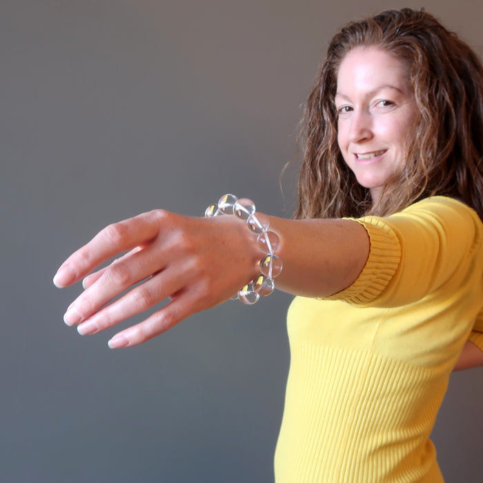 jamie of satin crystals with hand extended to show off her clear quartz bracelet