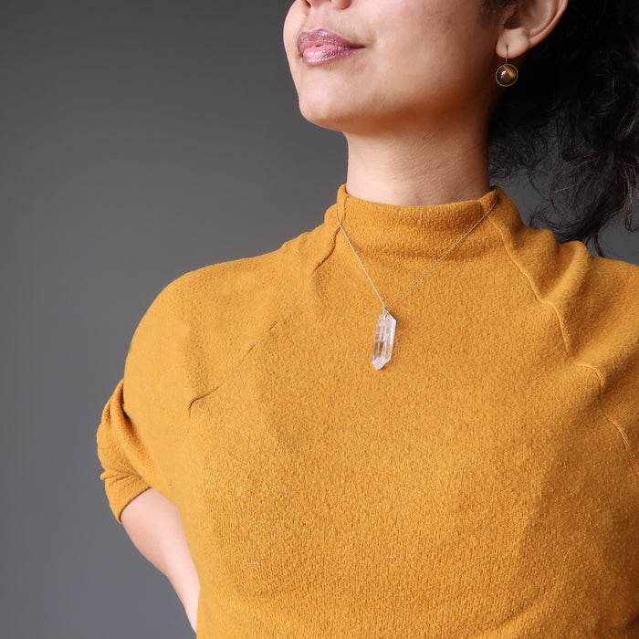 raw clear quarz point necklace on female model