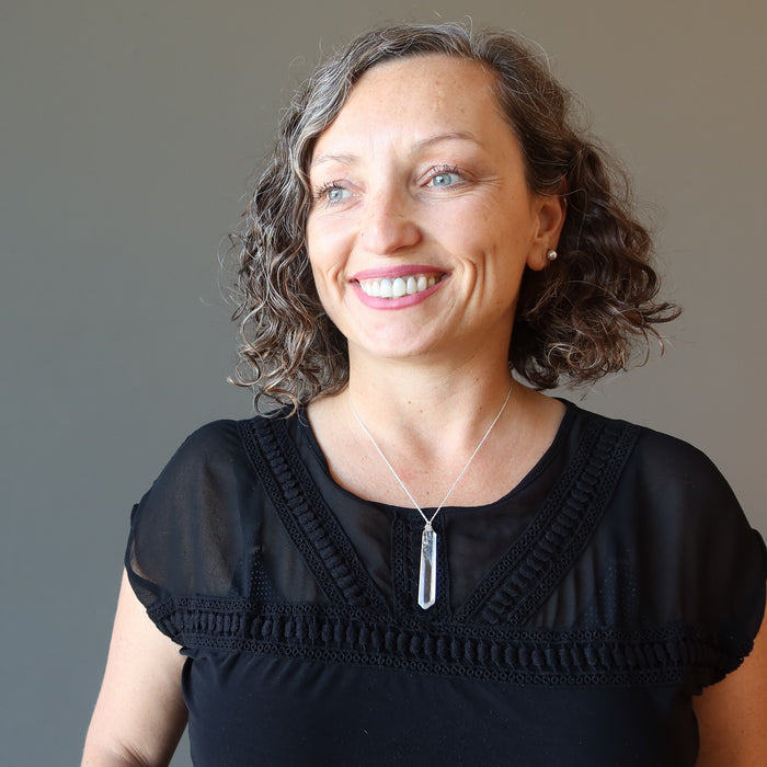 raw clear quarz point necklace on female model