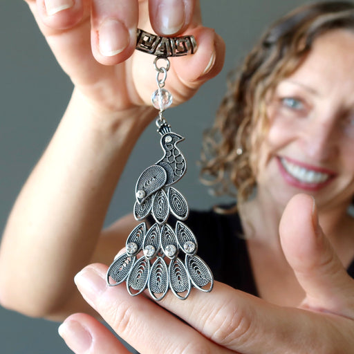 female model holding Clear Quartz decorated on silver Peacock Pendant  