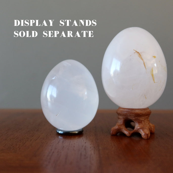 two different size eggs on the stands