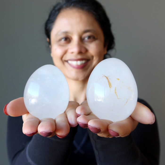 sheila of satin crystals holding two Cloud Quartz Eggs one on each palm