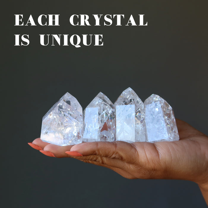 4 Rainbow Crackle Quartz Point Wand Towers on model palm showing each is unique