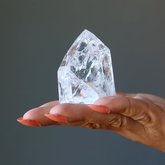 Rainbow Crackle Quartz Point Tower on the model palm