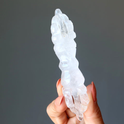 hand holding clear quartz dorje wand