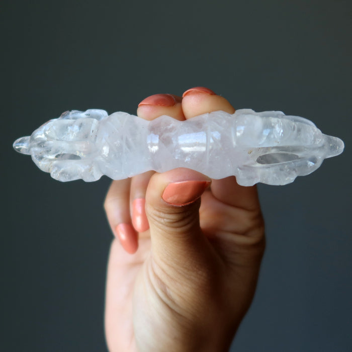 hand holding clear quartz dorje wand